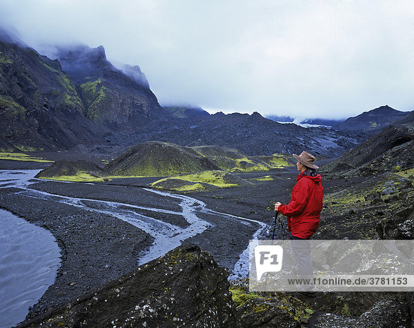 Hiker looks over the end moraine of the Thungnakvislajoekull  Thorsmoerk  Iceland