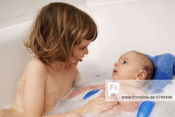 Kleines Mädchen sitzt mit ihrem Bruder in der Badewanne (4 Jahre  2 Monate)