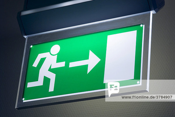 Illuminated sign shows the way to the emergency exit