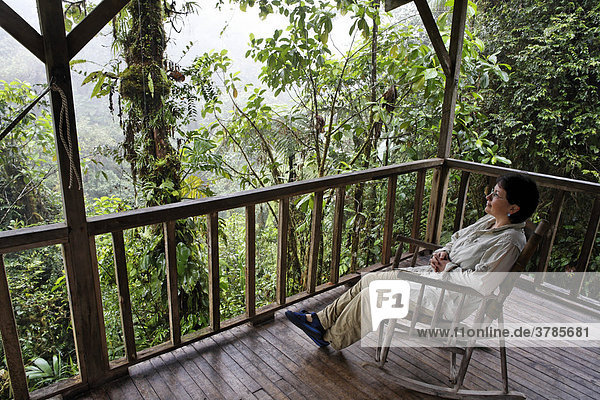 Woman in rocking chair  Rara Avis Lodge  River Edge Cabin  Las Horquetas  Costa Rica