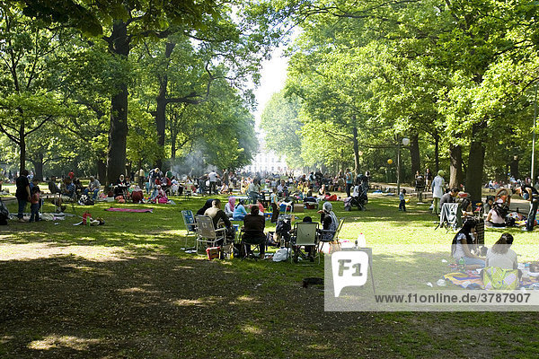 Families having a barbecue in the Tiergarden with Castle Bellevue in the background  Berlin  Germany