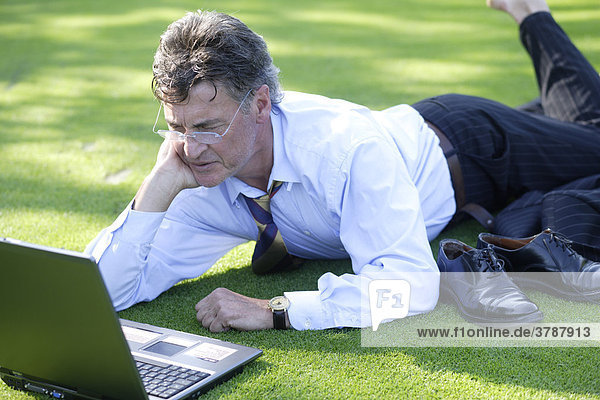 Manager working on notebook in park