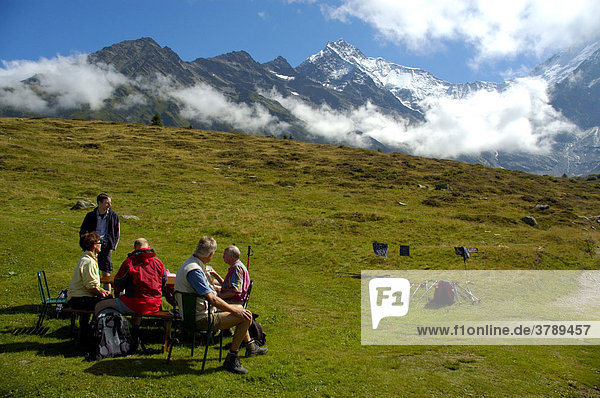 Hiking group rests on a meadow at Mont Truc Haute-Savoie France