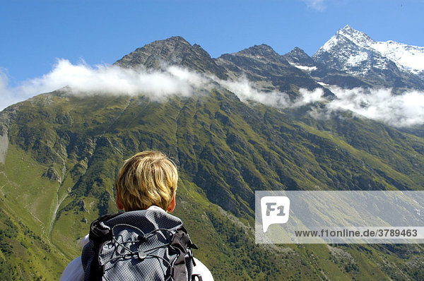 Hiking woman looks at the mountains Aigle de Tricot Haute-Savoie France