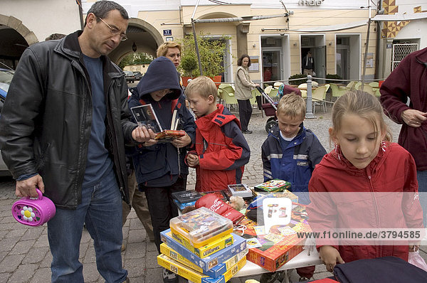 Father with children at the toy flea market in Klosterneuburg near Vienna Austria
