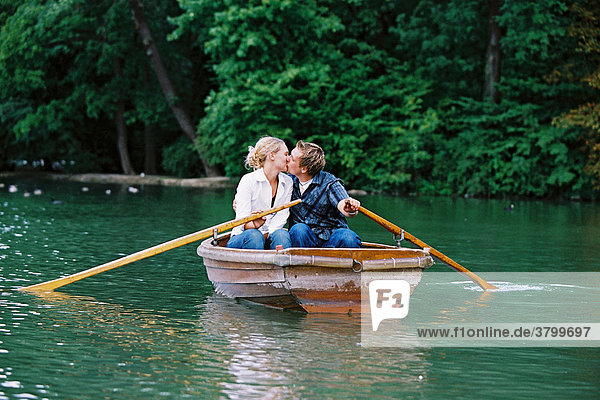 Couple in rowing boat kissing