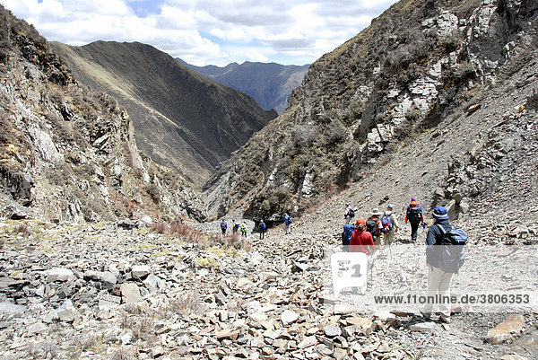 Trekking group descends through rocky gorge from Chitu-La Pass Tibet China