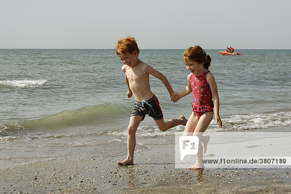 Mr two childrn are running at the beach
