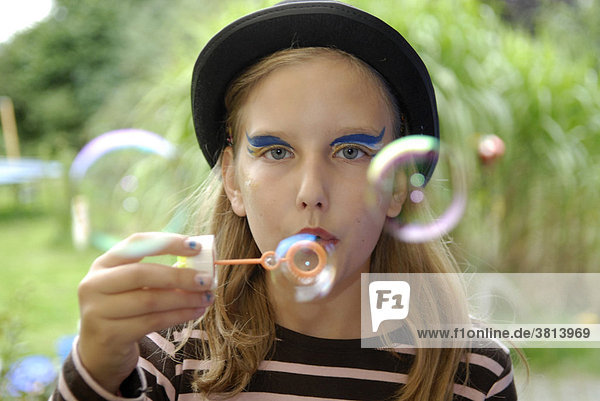 Girl with soap bubbles with a birthday celebration