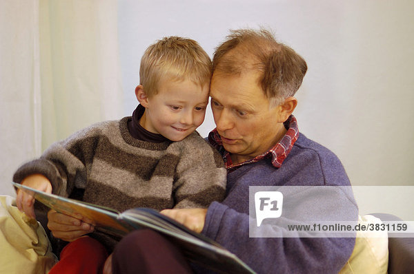 Father reading to his little five year old boy a picture book picture-book