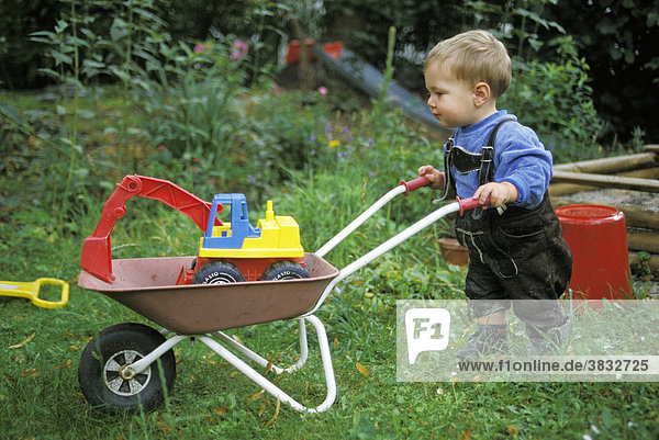 One-year-old with wheelbarrow and leather trousers MR