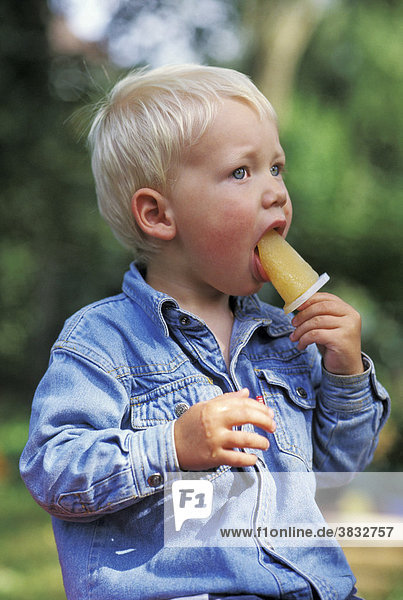 Two-year-old boy eating ice