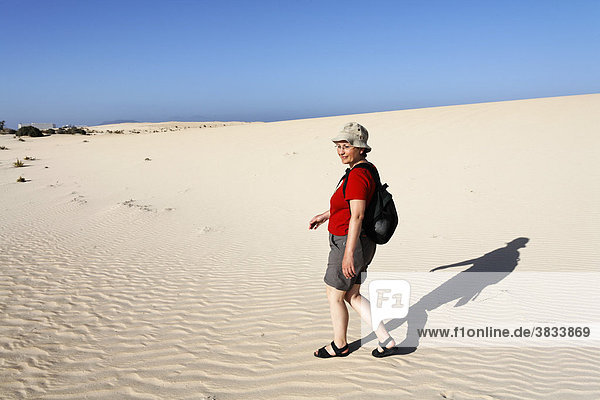Hiker in dunes of Corralejo   Fuerteventura   Canary Islands