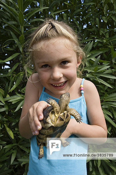 Child with tortoise  Sardinia  Italy