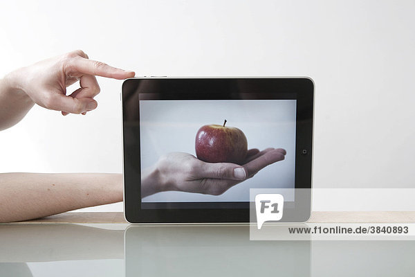 IPad  hand with an apple