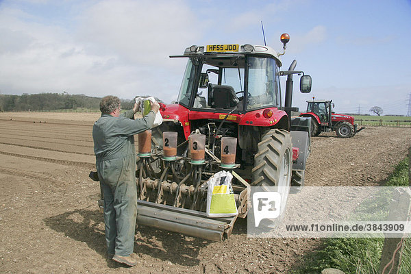 Farmer refilling seed drill with coated spinach seed  Dorset  England  United Kingdom  Europe
