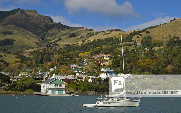 Sailing boat  boathouse and coastal village  Akaroa Harbour  Banks Peninsula  South Island  New Zealand