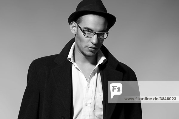 Portrait of a young man in a suit  shirt  jacket and hat