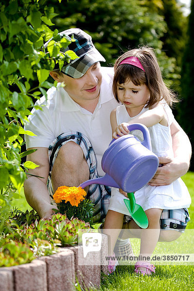 Father and daughter working in the garden