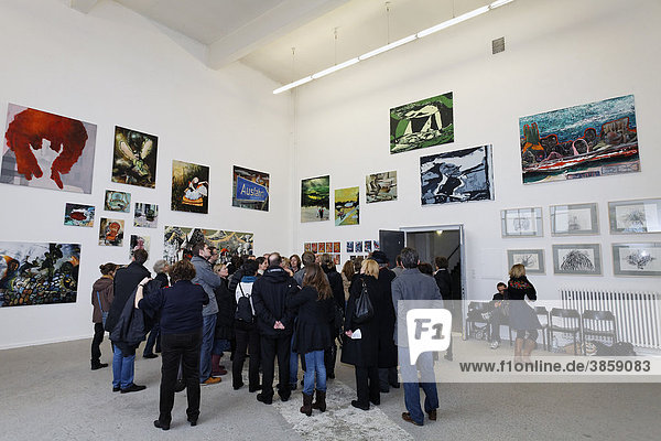 Visitor group looking at paintings by art students  tour Kunstakademie Art Academy in Duesseldorf  North Rhine-Westphalia  Germany  Europe