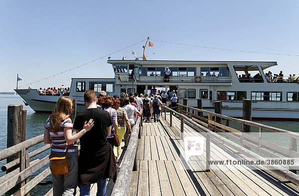 Tourists boarding a ferry  lake Chiemsee  Chiemgau  Upper Bavaria  Germany  Europe