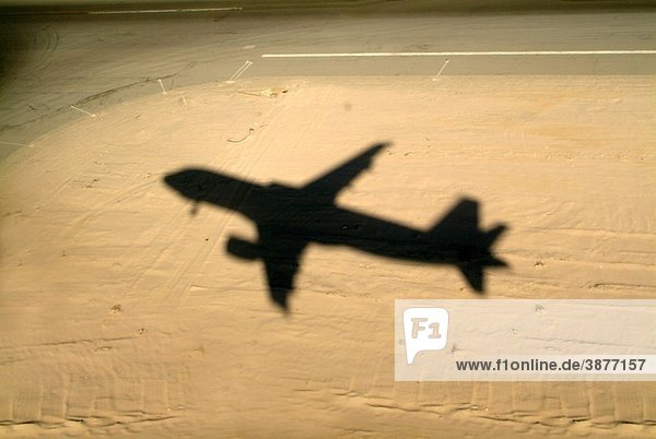 Egypt red sea hurgada airport shadow of a flying airplane ready to land