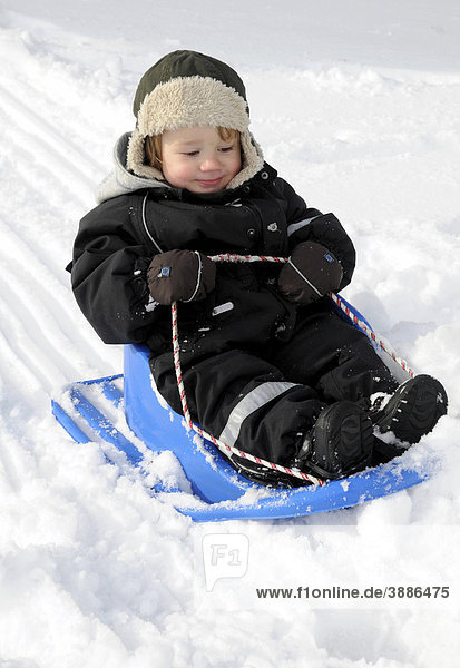 Little boy playing in snow