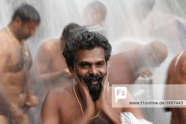 Men washing themselves in the Kutralam Waterfalls  Peraruvi  Main Falls  Kuttralam  Kuttalam  Courtallam  Western Ghats  Tamil Nadu  Tamilnadu  South India  India  Asia