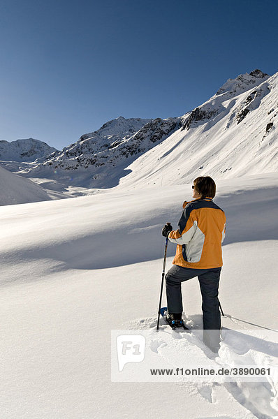 Man walking with snowshoes,  Rifflsee,  Pitztal,  Tyrol,  Austria,  Europe