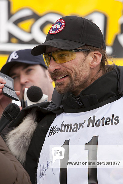 4 time consecutive Yukon Quest and Iditarod champion Lance Mackey being interviewed after coming in second  finish line  Yukon Quest 1  000-mile International Sled Dog Race 2010  Whitehorse  Yukon Territory  Canada
