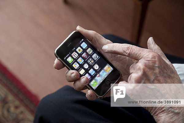 Elderly man using a smartphone  hands with iPhone