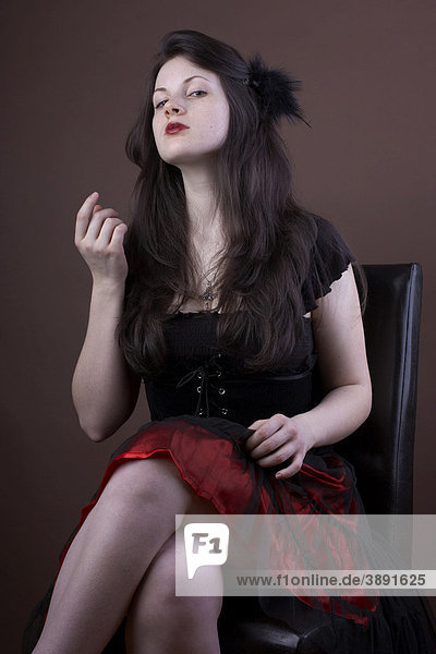 Woman  young  dark-haired  dress  serious  sitting