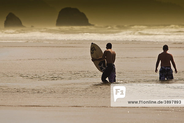 Surfers at Cannon Beach  Clatsop County  Oregon  USA