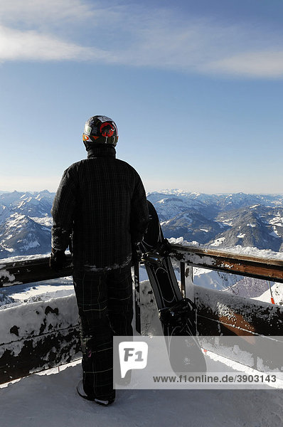 Snowboarder on a viewing platform  Mt Nebelhorn summit station  2224m  Oberstdorf  Allgaeu  Bavaria  Germany  Europe
