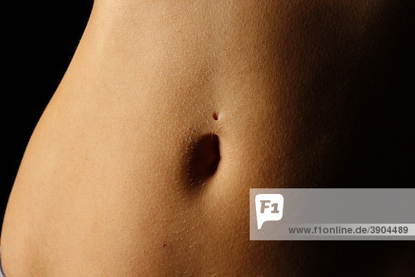 Belly of a young woman with a removed piercing