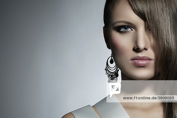 Portrait of a young woman  earring  direct look  fashion