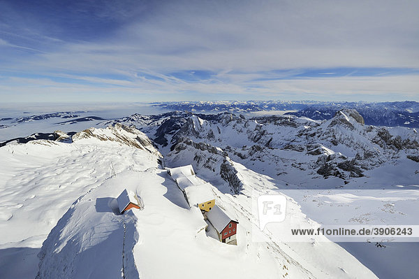 Snow-covered mountain restaurants on the 2500 meters high Mt Saentis  Allgaeu Alps and Voralberg Alps in the back  Canton of Appenzell Ausserrhoden  Switzerland  Europe