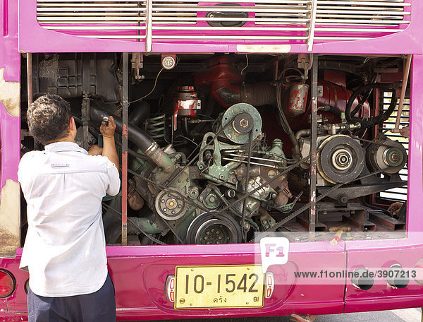 Replacing a V-belt in an intercity bus  Trang Province  Thailand  Asia
