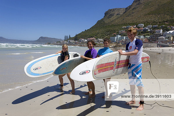 Group of young surfers on the beach in Muizenberg  Cape Town  Western Cape  South Africa  Africa