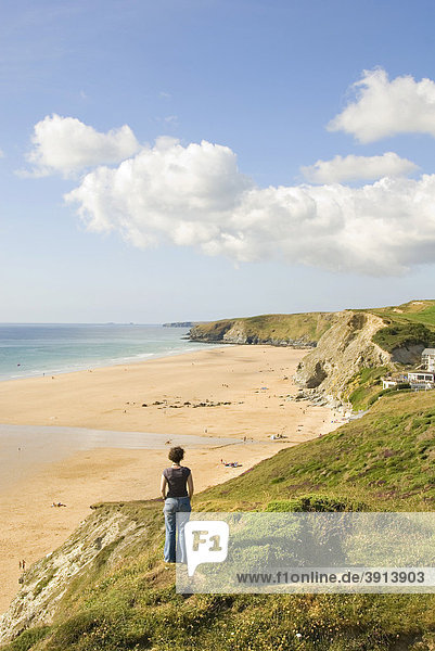 Frau auf Klippe schaut auf Strand  Küste  Watergate Bay  Cornwall  Südengland  England  Großbritannien  Europa