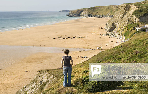 Frau auf Klippe schaut auf Strand  Küste  Watergate Bay  Cornwall  Südengland  England  Großbritannien  Europa