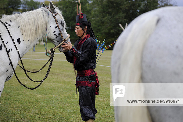 A Korean participant in a classic costume with his horse  open Eocha European championship 09  mounted archery with steppe riders from all over the world  Trossenfurt  Franconia  Bavaria  Germany  Europe