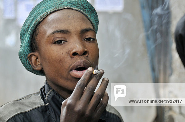 Street child consuming drugs  cigarettes  in Hillbrow  Johannesburg  South Africa  Africa