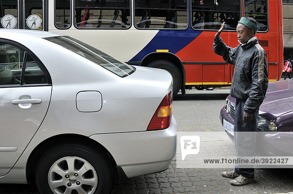 Street child earning money by performing simple jobs  parking assistance  Hillbrow  Johannesburg  South Africa  Africa