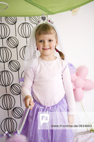 Mädchen im Kinderzimmer mit Kostüm Prinzessin