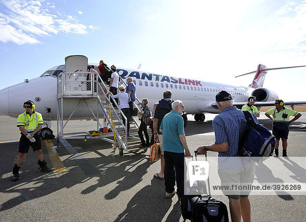 Passengers boarding Qantas Airlines Boeing 717  Ayers Rock Airport  also known as Connellan Airport  Ayers Rock  Northern Territory  Australia