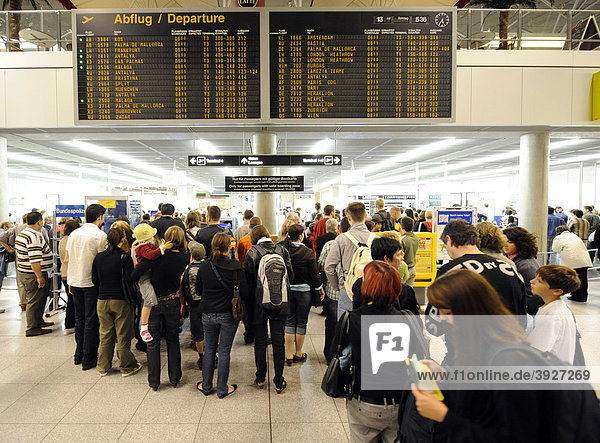 Passengers waiting in line at the check-in  departure board  Stuttgart Airport  Baden-Wuerttemberg  Germany  Europe