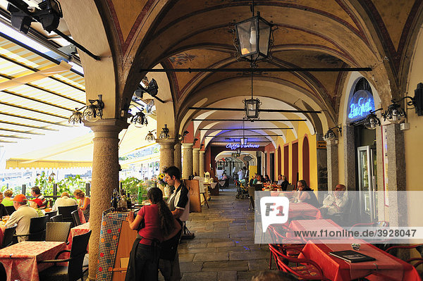 Arcades along the promenade with street restaurants  Lago Maggiore  Cannobio  Piedmont  Italy  Europe