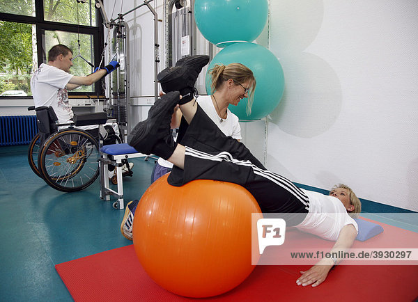 Gymnastic exercises with a therapy ball  physiotherapy  physical therapy in a neurological rehabilitation centre  Bonn  North Rhine-Westphalia  Germany  Europe