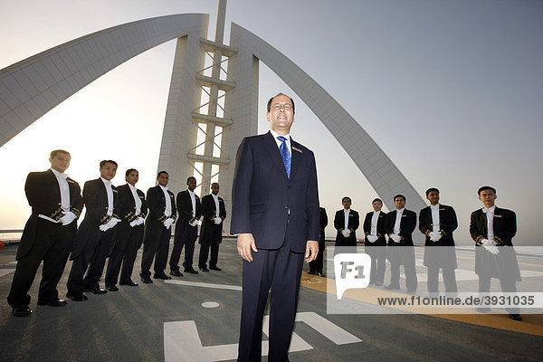 Butlers are lined up on the helicopter pad on the roof of the Burj Al Arab luxury hotel to receive a VIP guest  Dubai  United Arab Emirates  Middle East